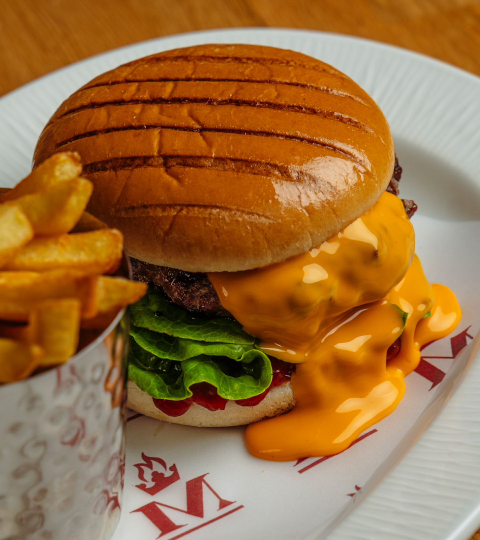 Hamburger with melted cheese and crispy chips in our restaurant.