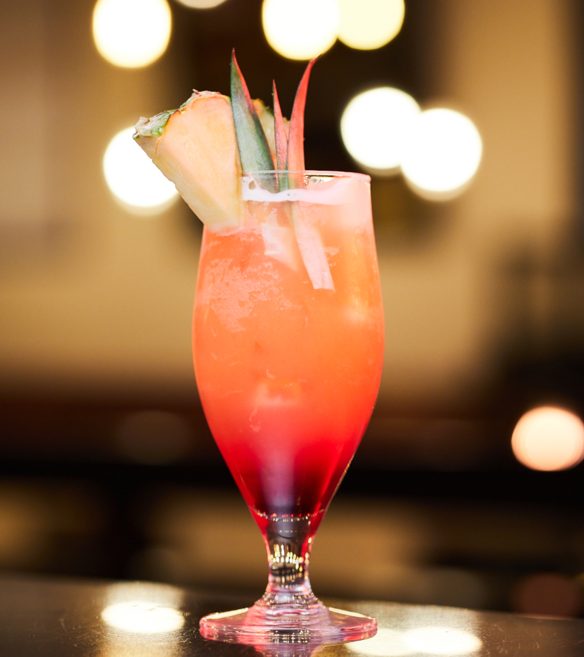 Colourful cocktail with pineapple decoration.