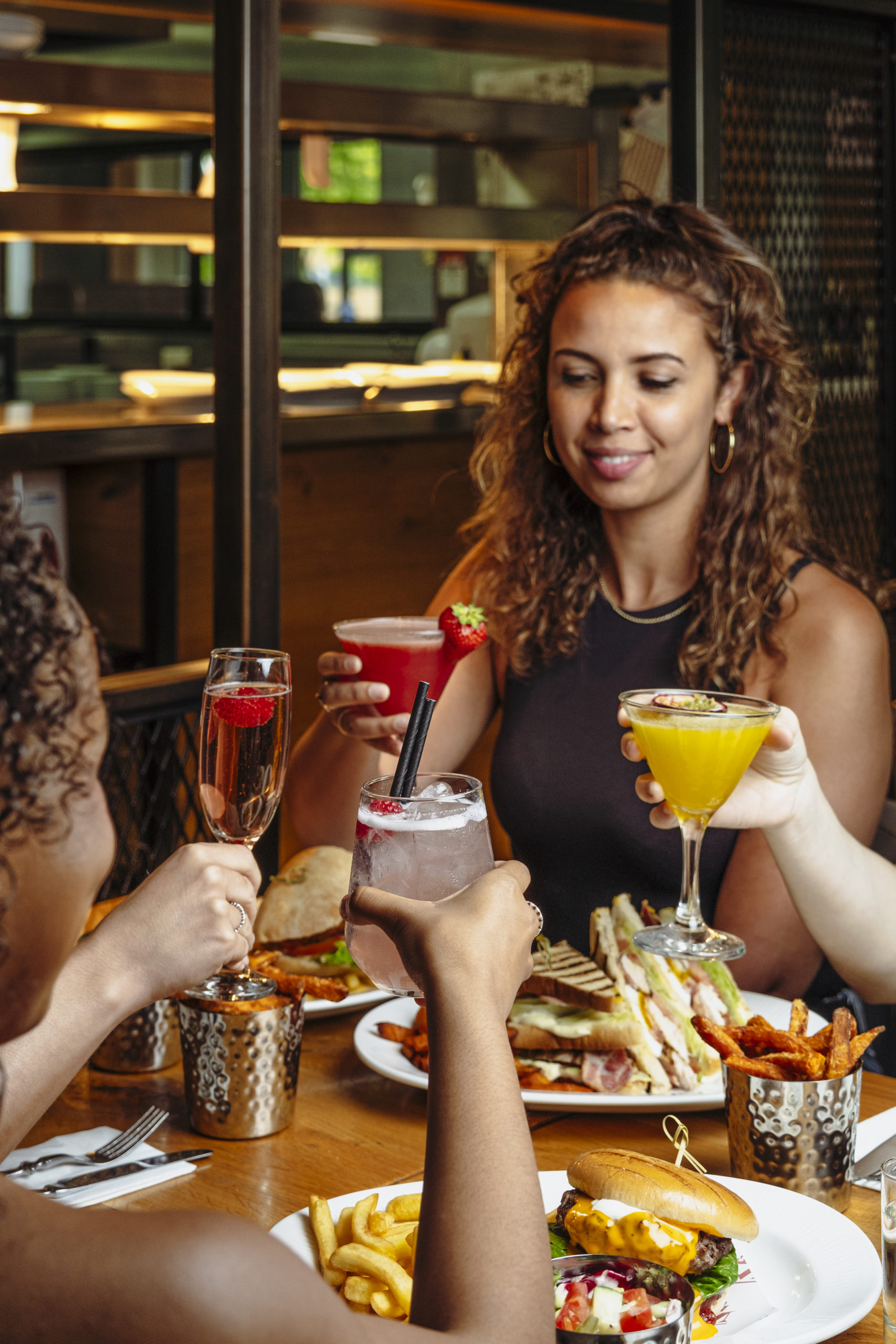 Four friends are enjoying a meal and cocktails in Middletons.